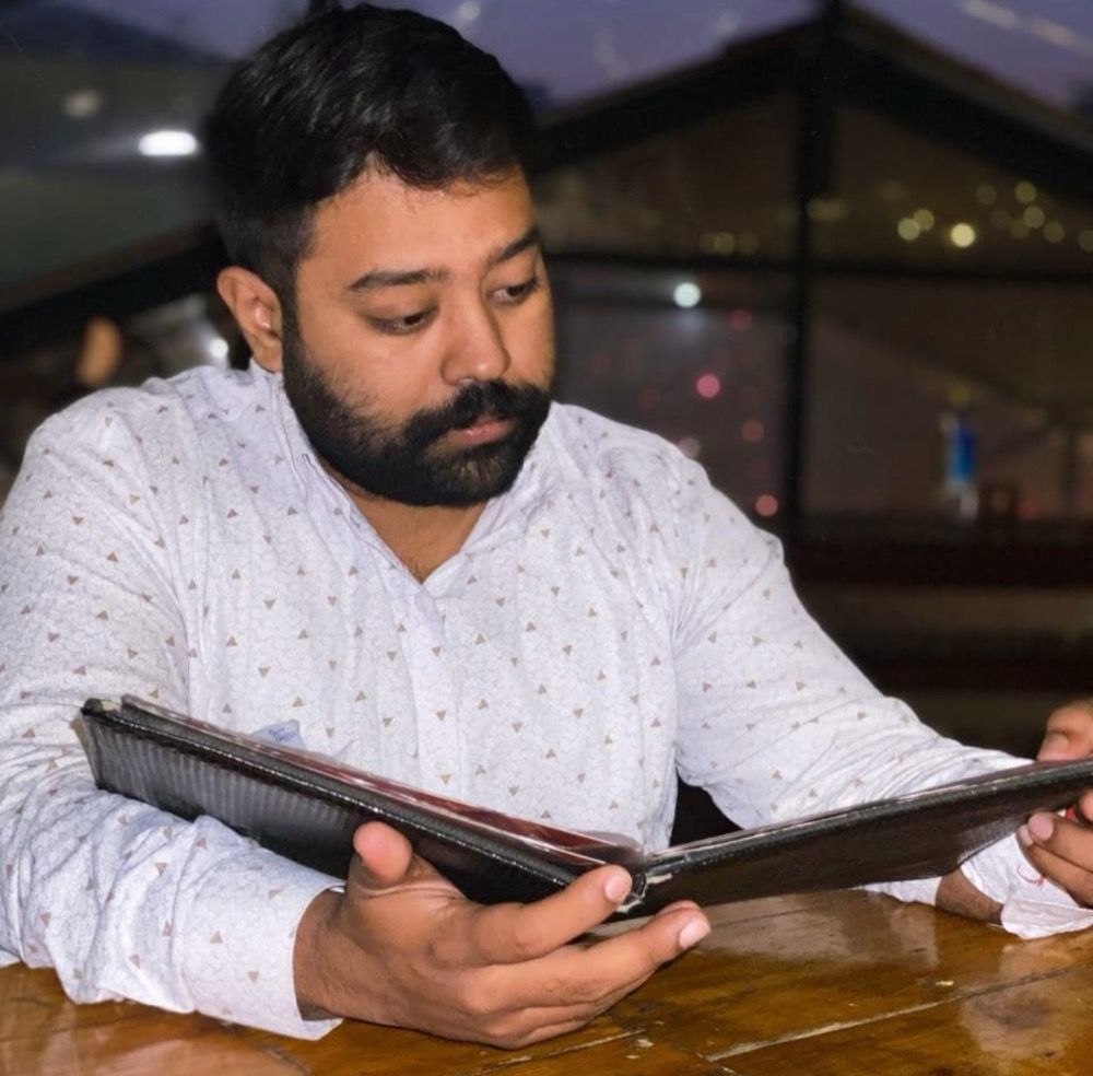 Er. Rohit Kumar, founder of WEE CONSTRUCT, reading through a project file